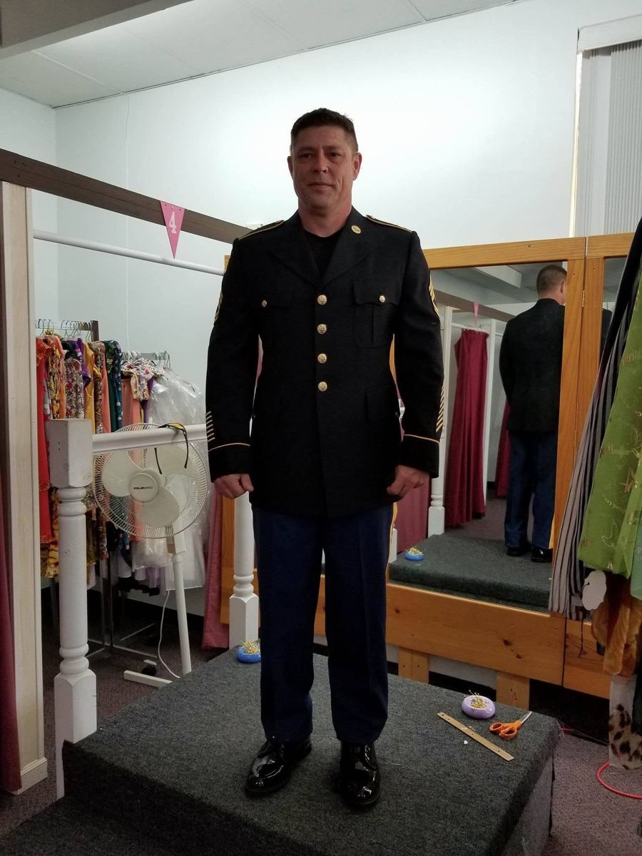 A customer in a fitted dress uniform jacket and trousers